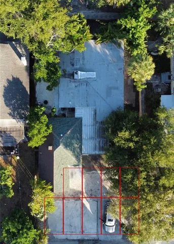 a living room with furniture a chandelier and a dining table