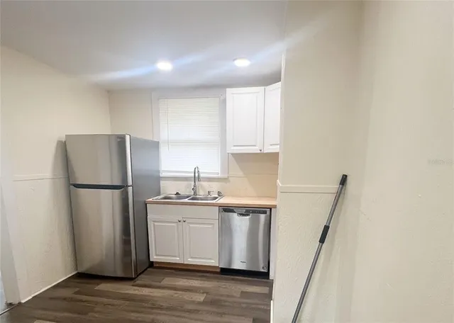a bathroom with a sink a mirror a toilet and vanity