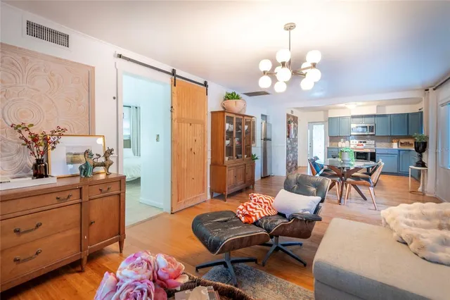 a dining room with furniture and wooden floor
