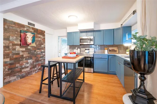 a bedroom with bed and wooden floor