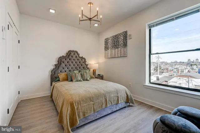 a bedroom with a bed lamp and window