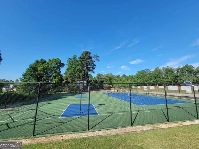 a view of a playground with basketball court
