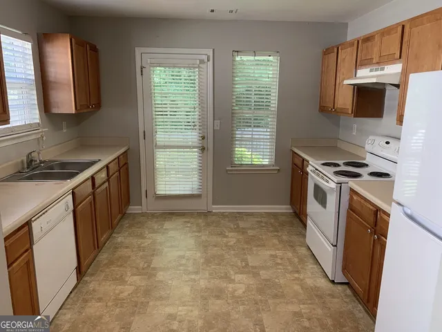 a kitchen with a stove a sink and a microwave