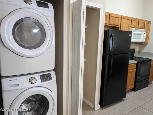 a view of a kitchen with refrigerator and washer