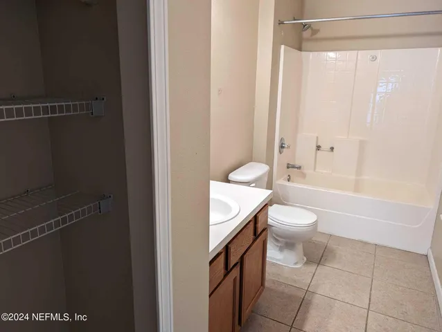 a bathroom with a toilet a sink and shower