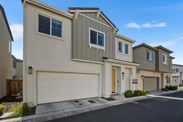 a kitchen with stainless steel appliances granite countertop a table chairs sink refrigerator and microwave