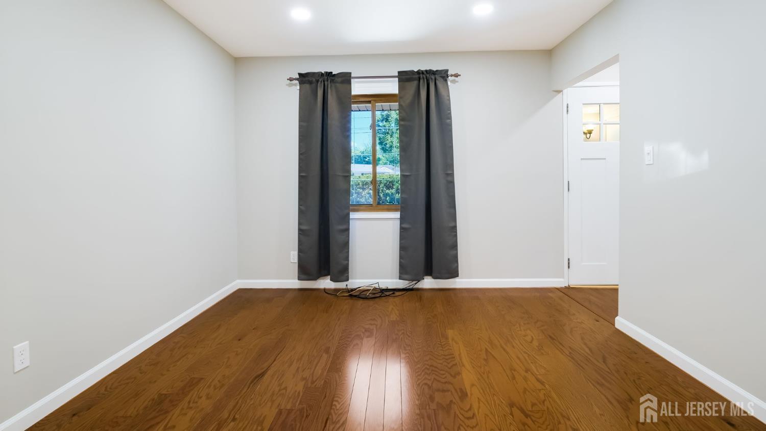 50 Sand Hills Road Kendall Park, NJ 08824 - Photo 11 of 27 a view of an empty room with wooden floor and a window