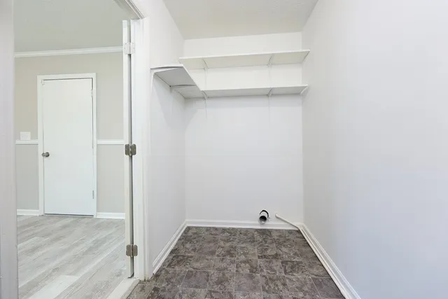 an empty room with a ceiling fan and carpet