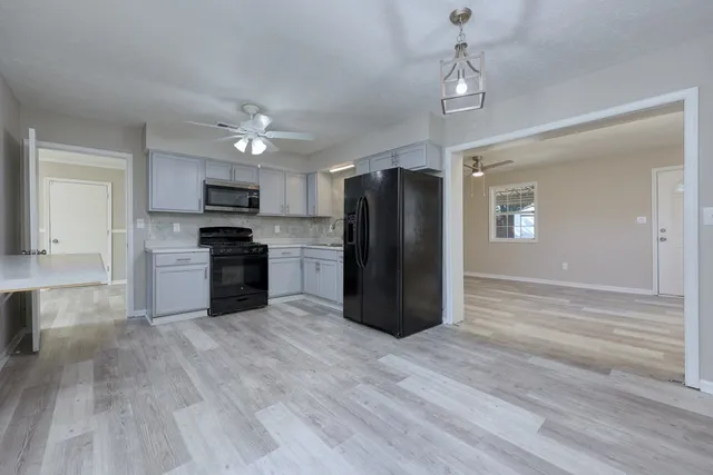 a kitchen with a stove cabinets and a refrigerator