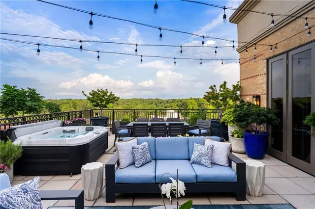 a view of an outdoor space with dining table and chairs