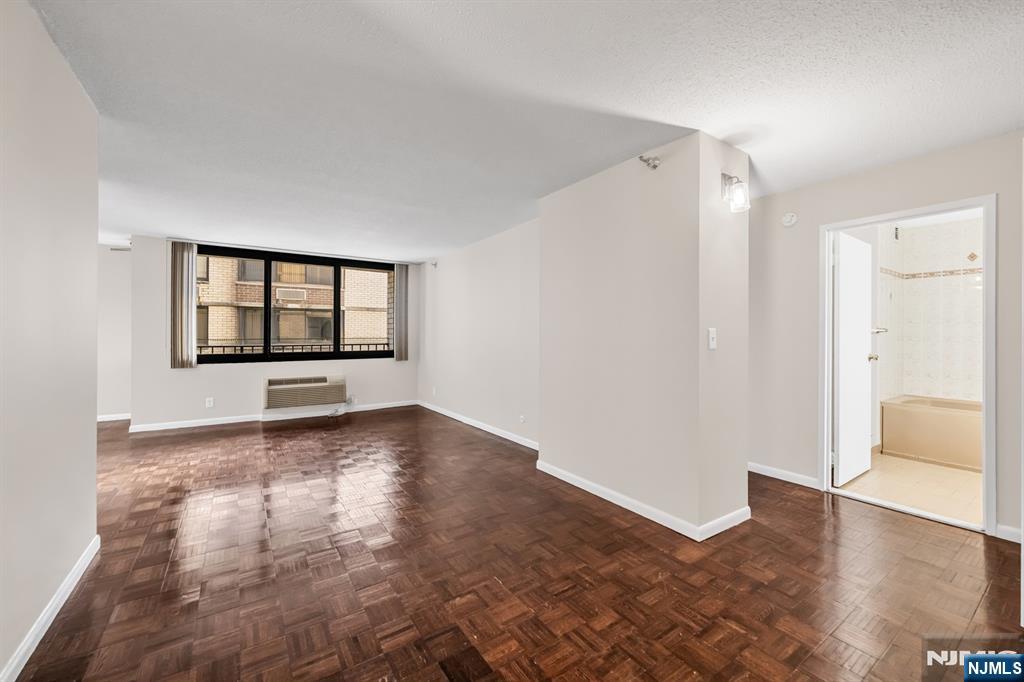 326 Prospect Avenue, Unit 6J Hackensack, NJ 07601 - Photo 12 of 18 wooden floor in an empty room with a window