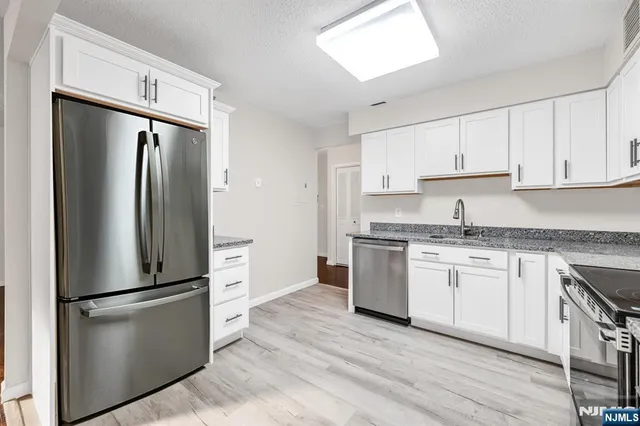 a kitchen with a refrigerator stove and sink