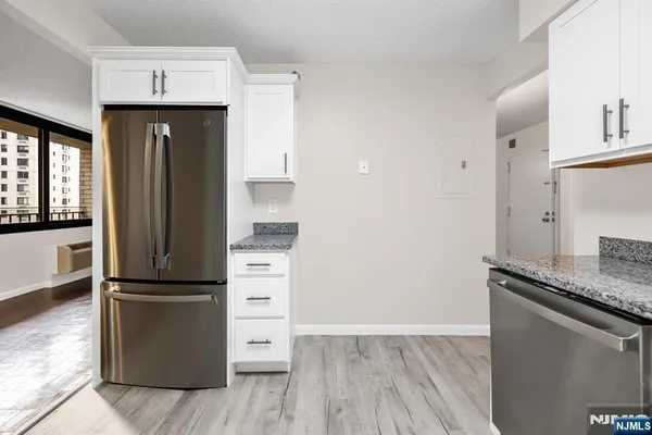 a kitchen with a refrigerator and a sink