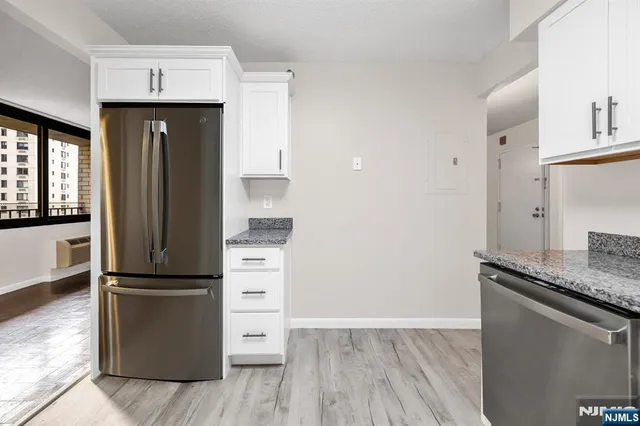 a kitchen with a refrigerator and a sink