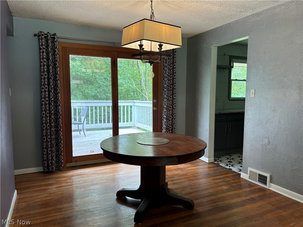 7595 Webster Road Cleveland, OH 44130 - Photo 17 of 45 Bright and airy dining room, adjacent to kitchen, opens to the living room and offers access to the deck