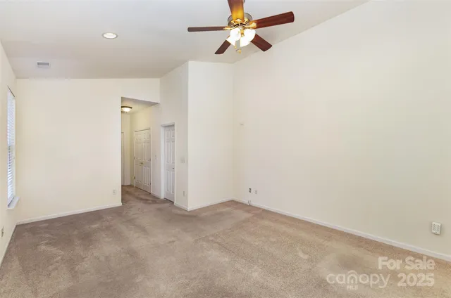 a view of a room with a ceiling fan