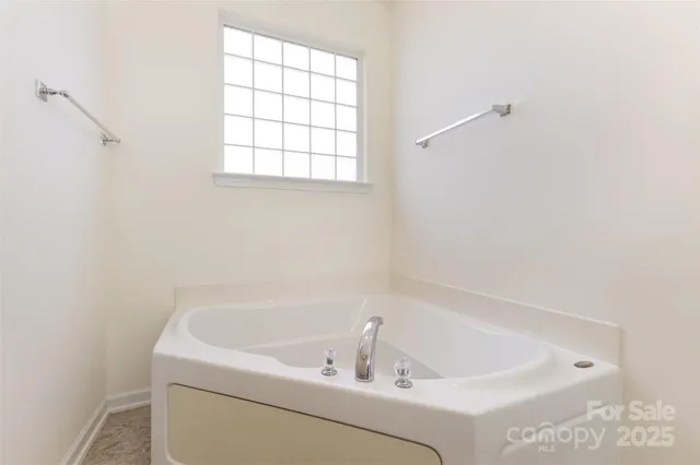 a white bath tub sitting next to a window