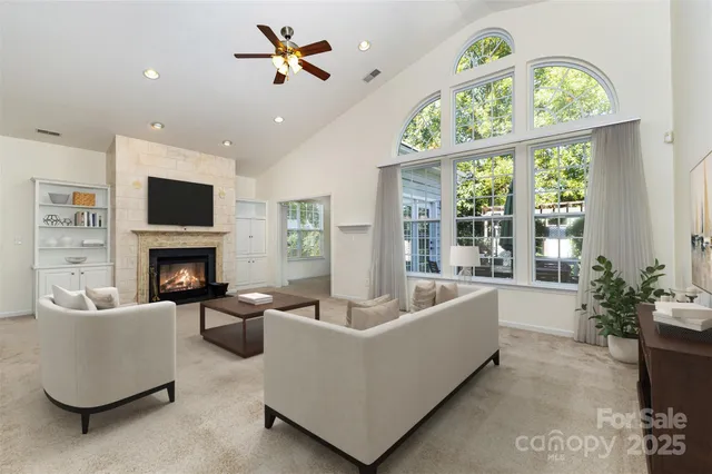 a living room with furniture a fireplace and a flat screen tv