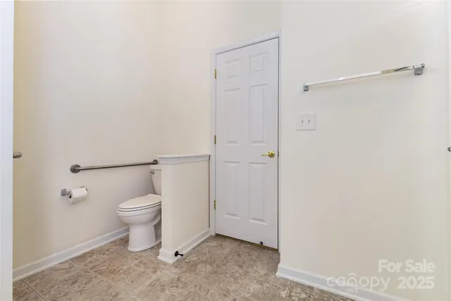 a white toilet sitting next to a bathroom sink