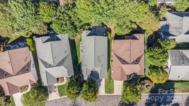 an aerial view of a house with a yard and fountain