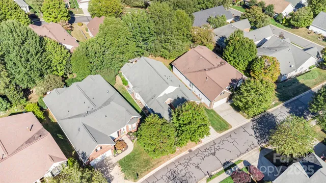 an aerial view of multiple houses with yard