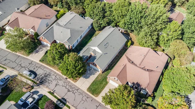 an aerial view of a house with a yard and garden