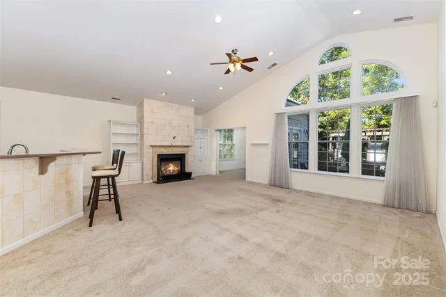 a big room with windows and a fireplace