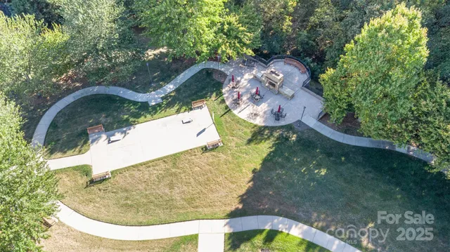 an aerial view of a house with a yard and a large pool