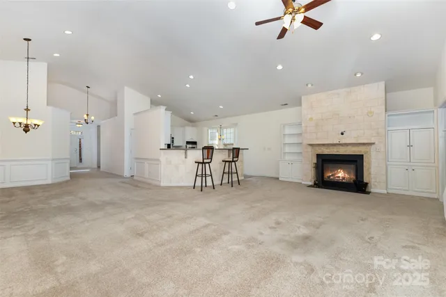 a view of a livingroom with a fireplace and a ceiling fan