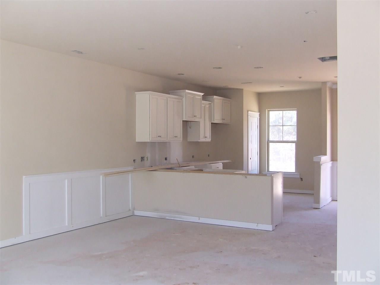 7912 Allscott Way Raleigh, NC 27612 - Photo 3 of 14 View from standing in family room looking towards kitchen and dining area. FR will have hardwoods!