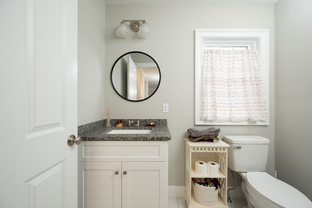 4 Rivers Edge Way, Unit 4 Assonet, MA 02702 - Photo 12 of 26 a bathroom with a toilet a sink and a mirror