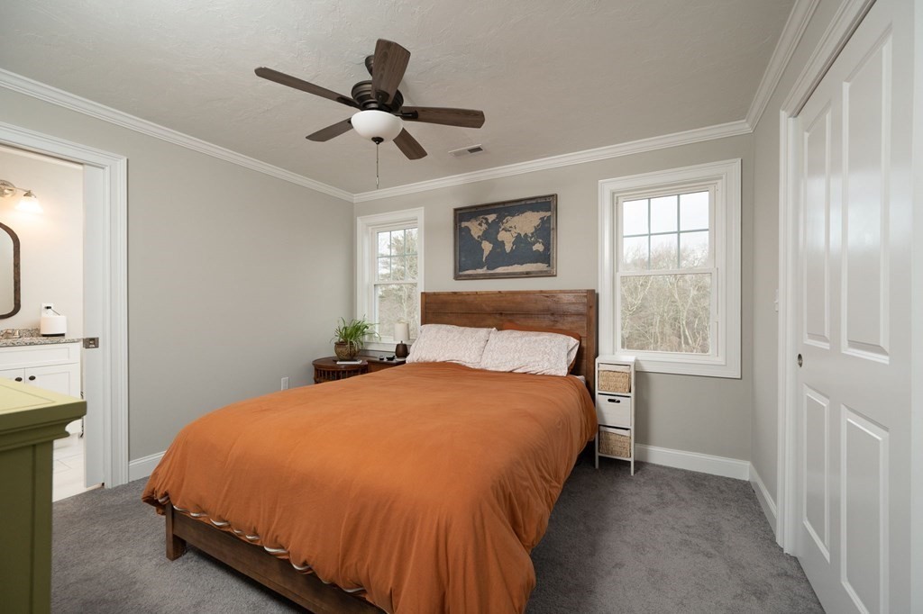 4 Rivers Edge Way, Unit 4 Assonet, MA 02702 - Photo 13 of 26 a bedroom with a bed and a chandelier