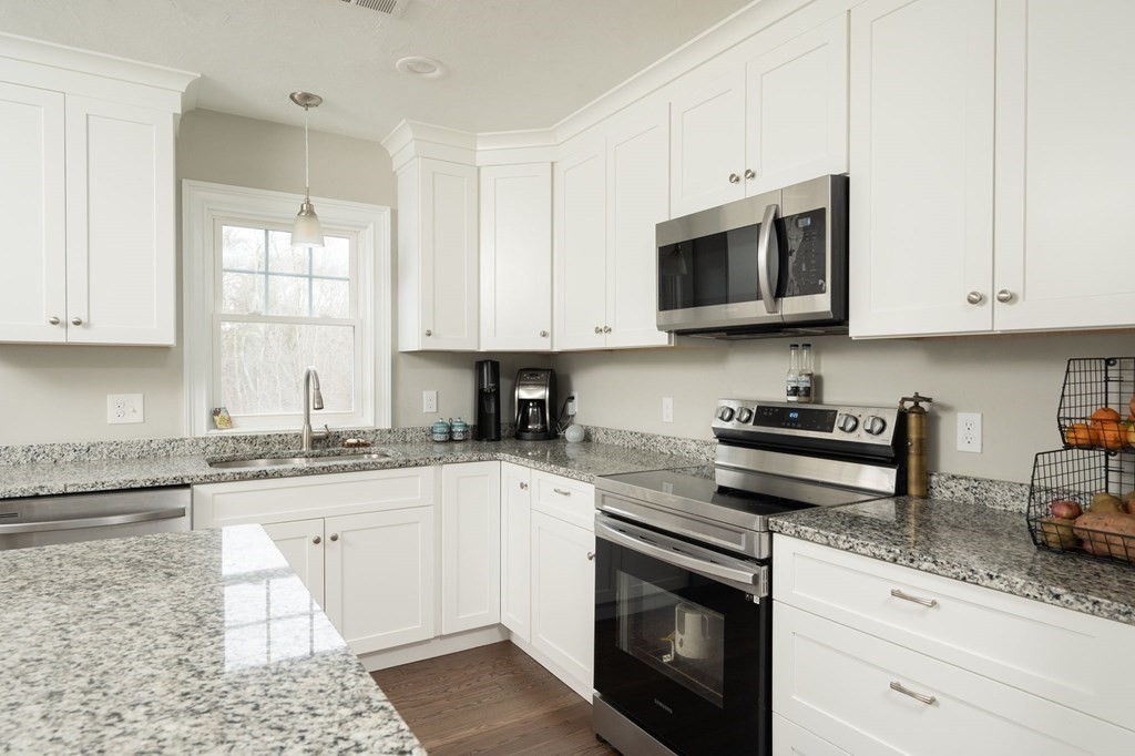 4 Rivers Edge Way, Unit 4 Assonet, MA 02702 - Photo 5 of 26 a kitchen with stainless steel appliances granite countertop a sink a stove and a microwave