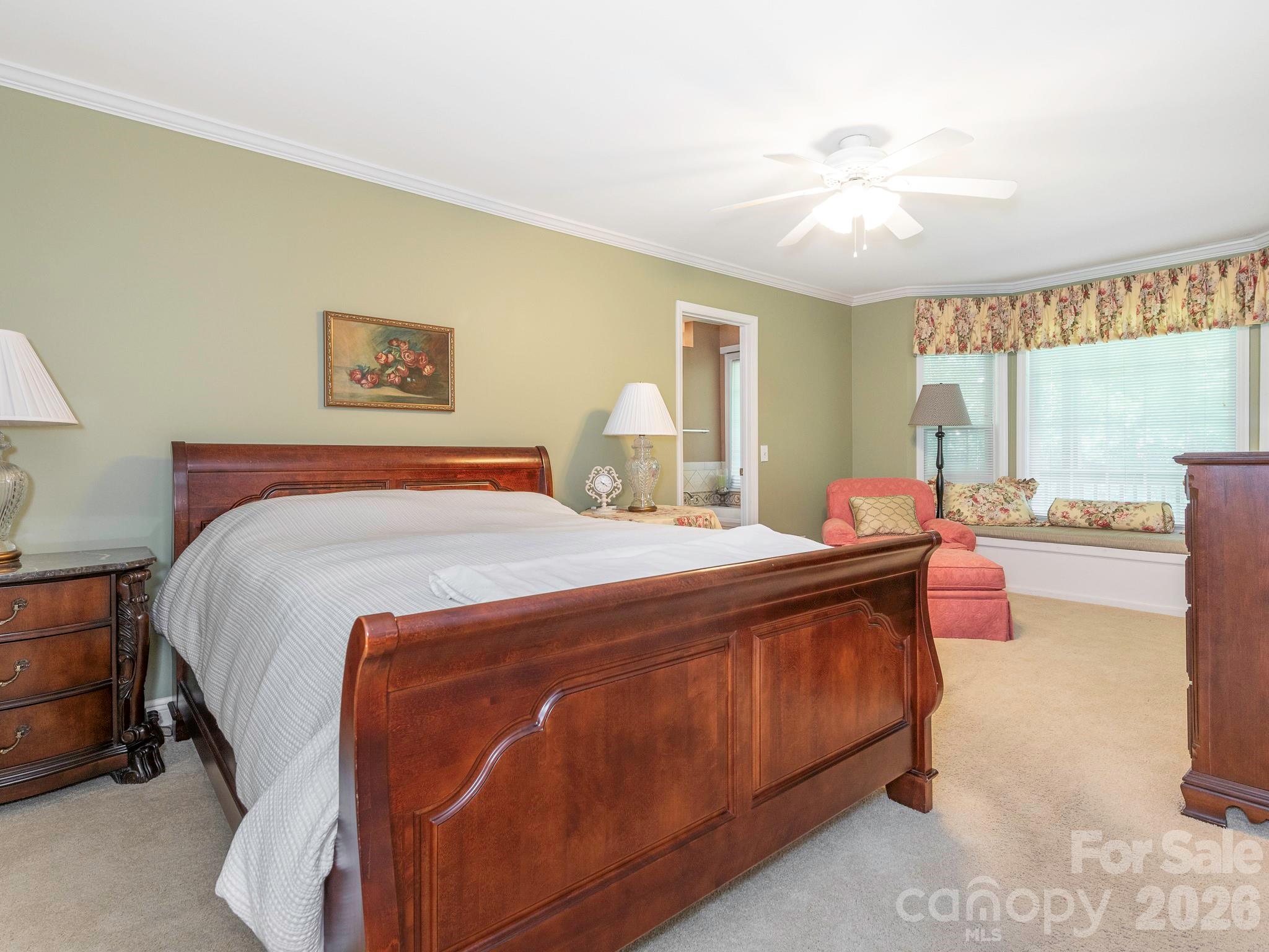 4440 Hucks Road Charlotte, NC 28269 - Photo 18 of 45 a spacious bedroom with a large bed and a chandelier