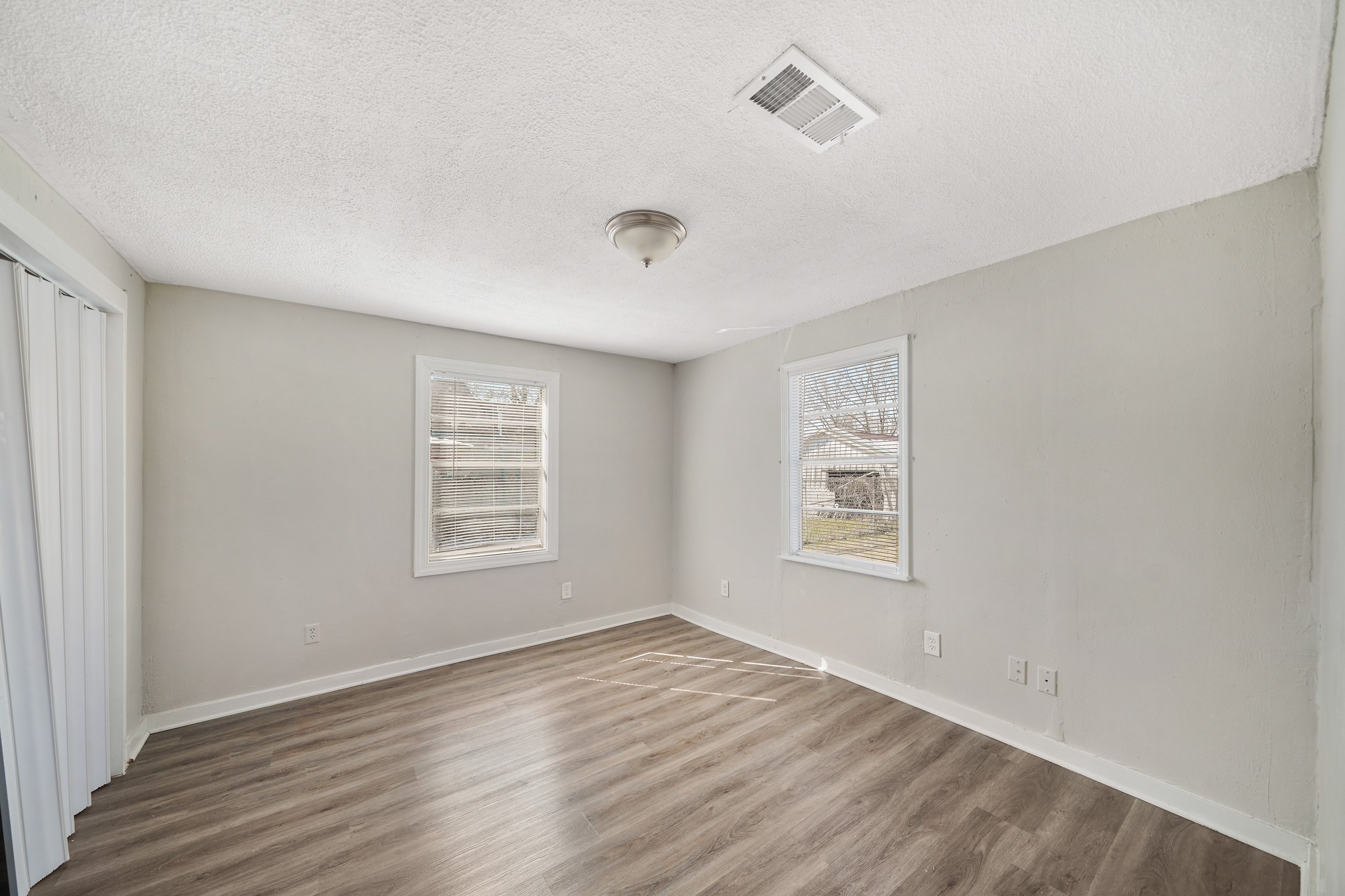 10001 Lucore Street, Unit FRONT Houston, TX 77017 - Photo 4 of 11 a view of an empty room with wooden floor and a window