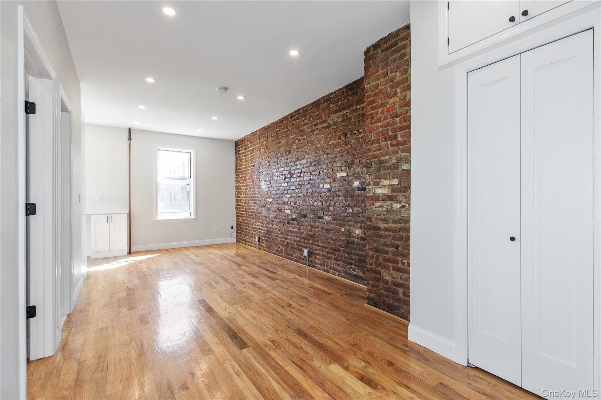 104-44 42nd Avenue Queens, NY 11368 - Photo 3 of 16 a view of empty room with wooden floor and fan