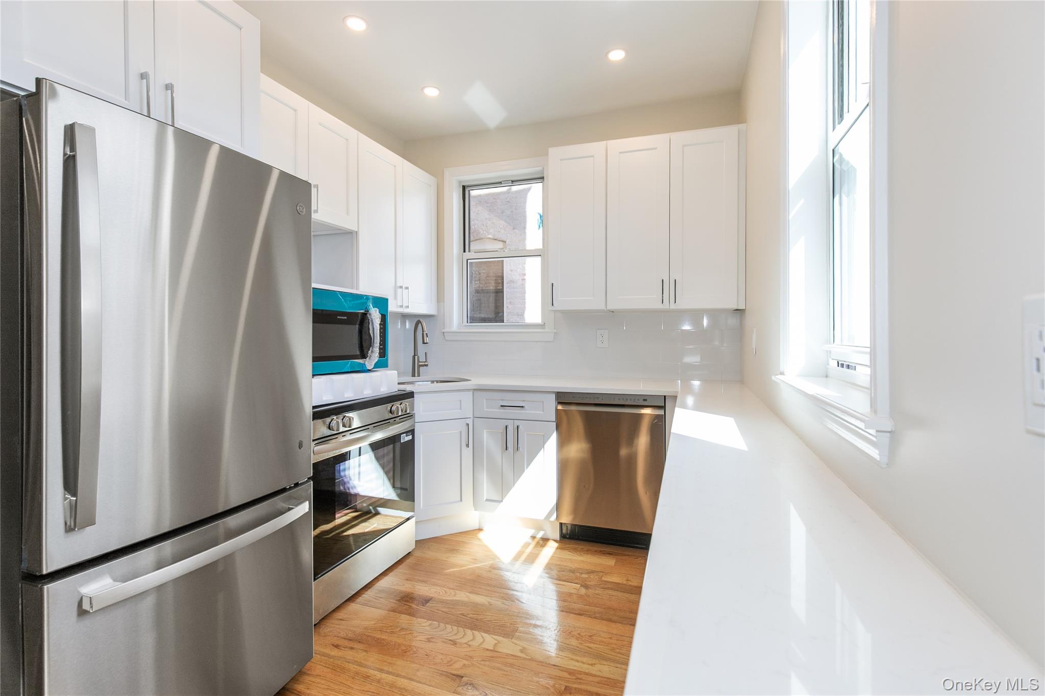 104-44 42nd Avenue Queens, NY 11368 - Photo 7 of 16 a kitchen with granite countertop a refrigerator stove and sink