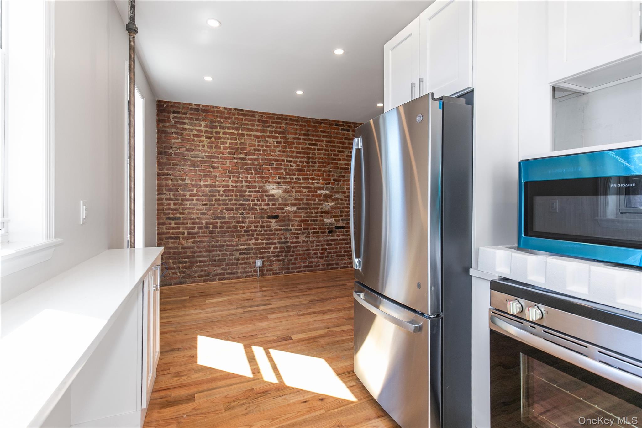 104-44 42nd Avenue Queens, NY 11368 - Photo 8 of 16 a kitchen with stainless steel appliances kitchen island granite countertop a refrigerator and a sink