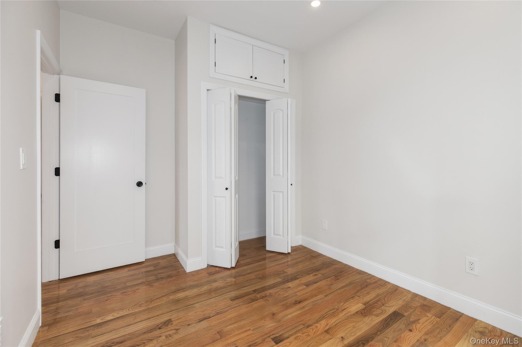 104-44 42nd Avenue Queens, NY 11368 - Photo 10 of 16 a view of an empty room with wooden floor