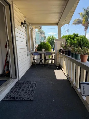 a view of balcony with furniture and garden