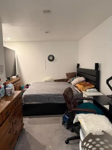 a bedroom with a bed and a chair