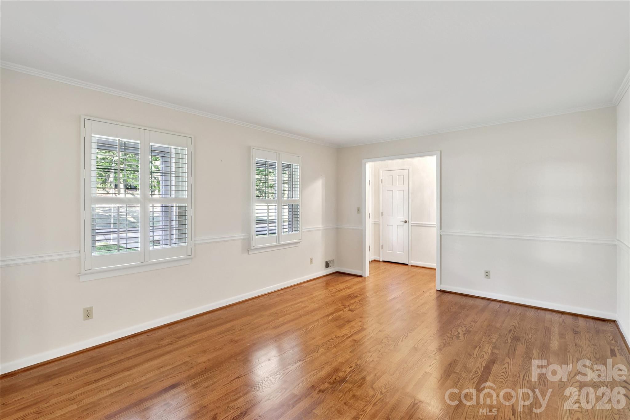 1002 Ridge Street Albemarle, NC 28001 - Photo 7 of 45 an empty room with wooden floor and windows