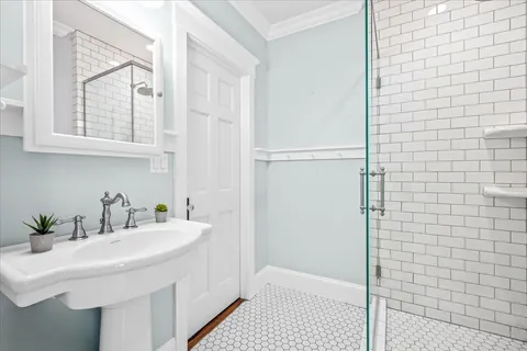 a bathroom with a sink a shower and a mirror