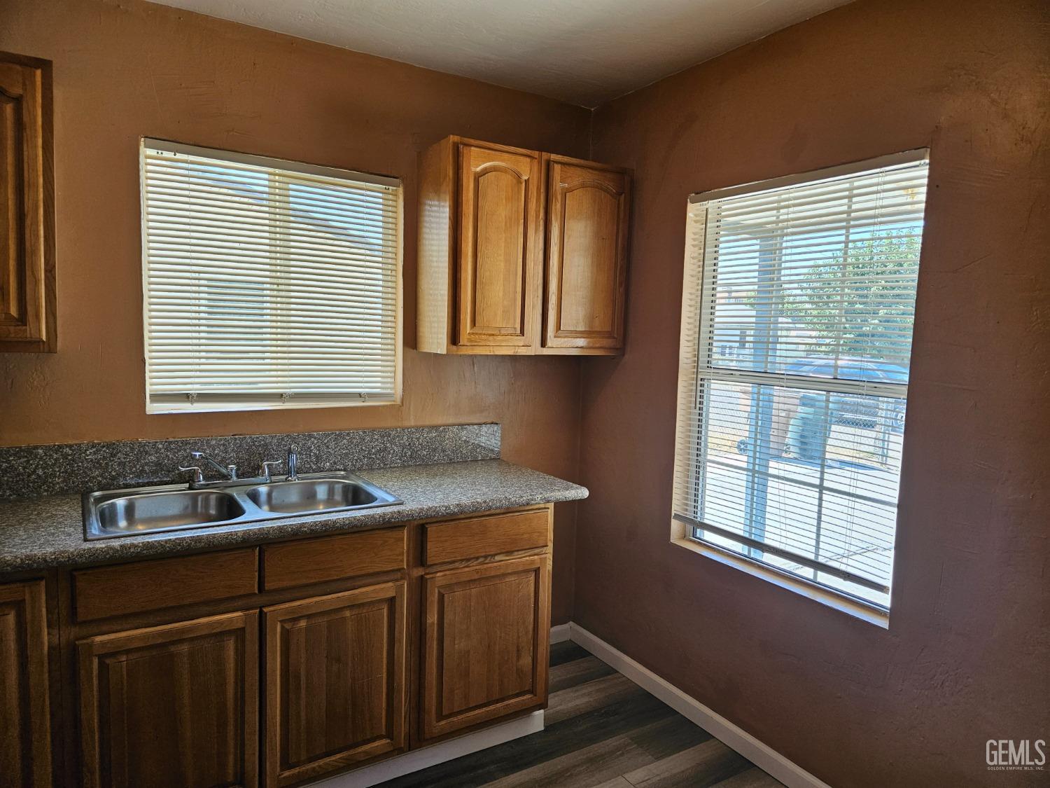Undisclosed Address Bakersfield, CA 93307 - Photo 7 of 17 a kitchen with a sink window and cabinets