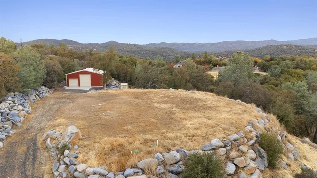 a view of a white house with a mountain in the background