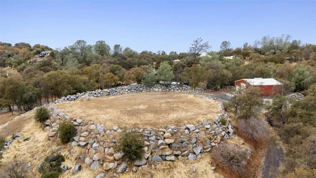 a view of a yard with trees in front of it