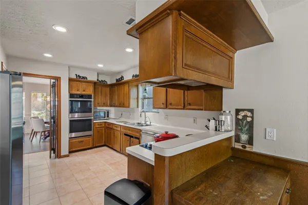 a kitchen with a sink refrigerator and cabinets