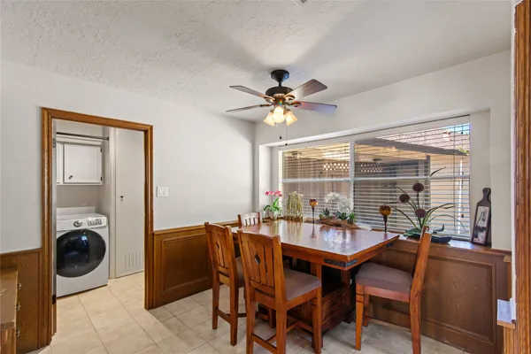 a dining room with furniture and window