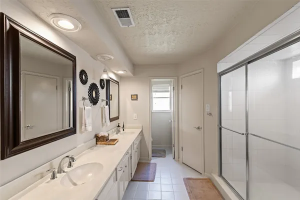 a bathroom with a tub sink and mirror