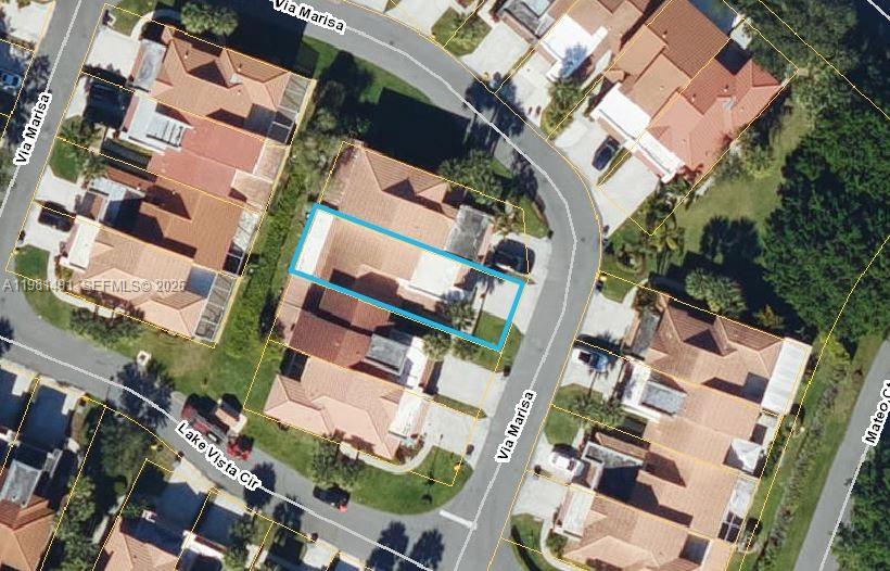 an aerial view of a building with a yard